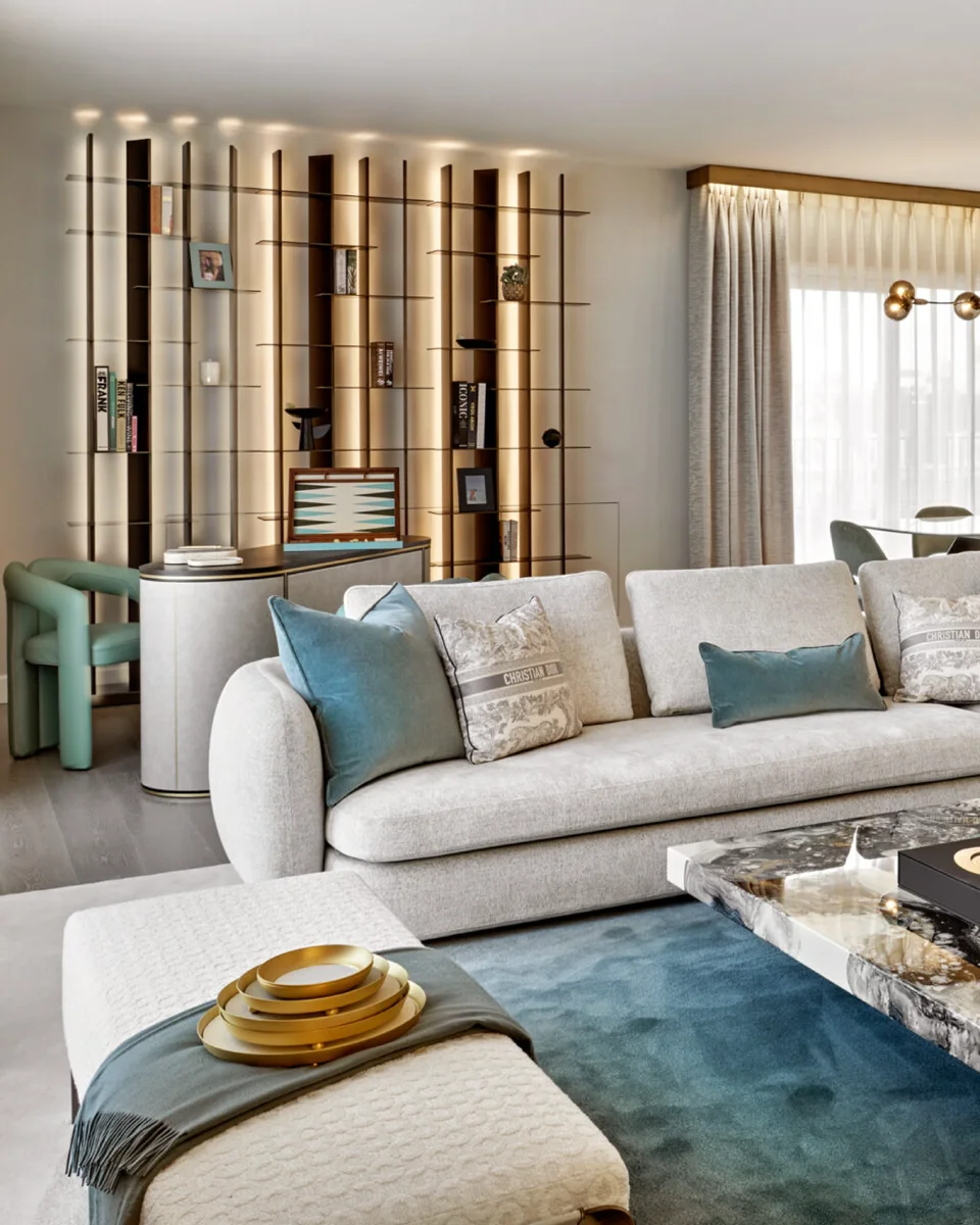 Living room with a cream sofa, teal cushions and illuminated bespoke shelving